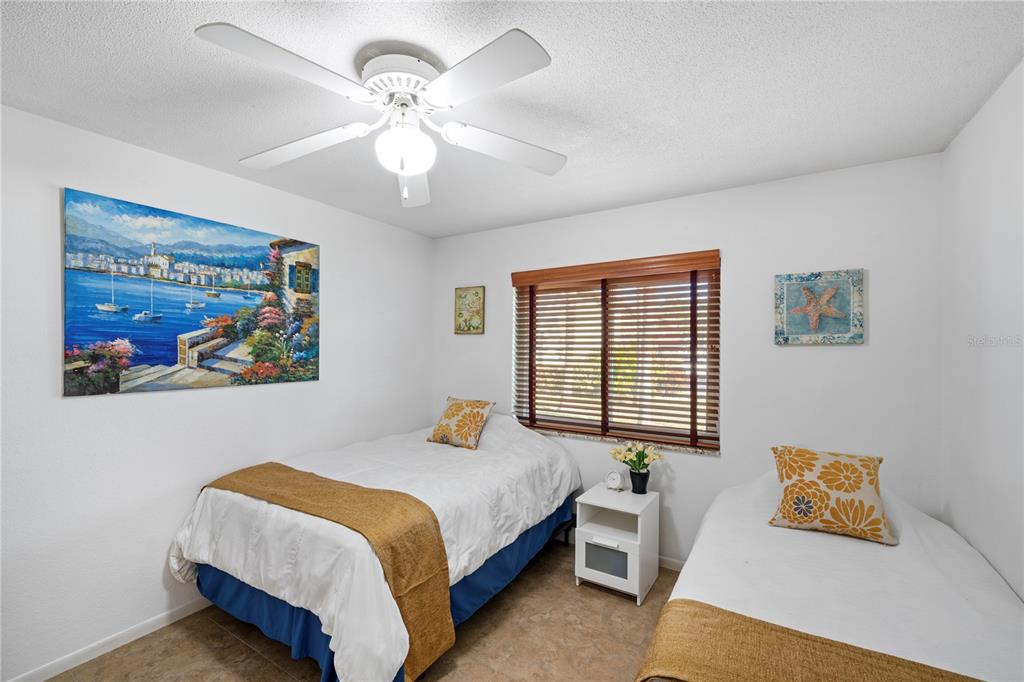 7360 Ulmerton Road, Unit 15D Largo, FL 33771 - Photo 29 of 75 a bedroom with a bed and a painting on the wall