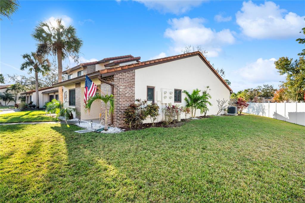 7360 Ulmerton Road, Unit 15D Largo, FL 33771 - Photo 3 of 75 a view of a house with a yard and a patio