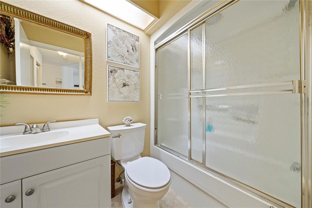 7360 Ulmerton Road, Unit 15D Largo, FL 33771 - Photo 33 of 75 a bathroom with a toilet a sink and mirror
