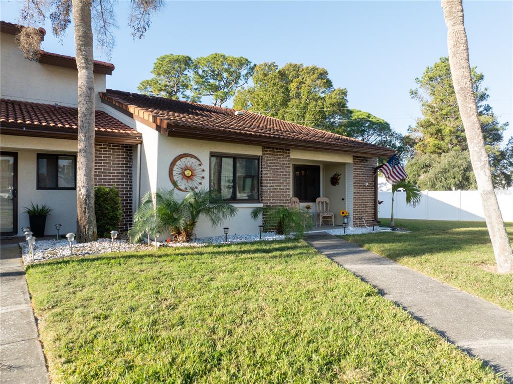 7360 Ulmerton Road, Unit 15D Largo, FL 33771 - Photo 74 of 75 a front view of a house with garden