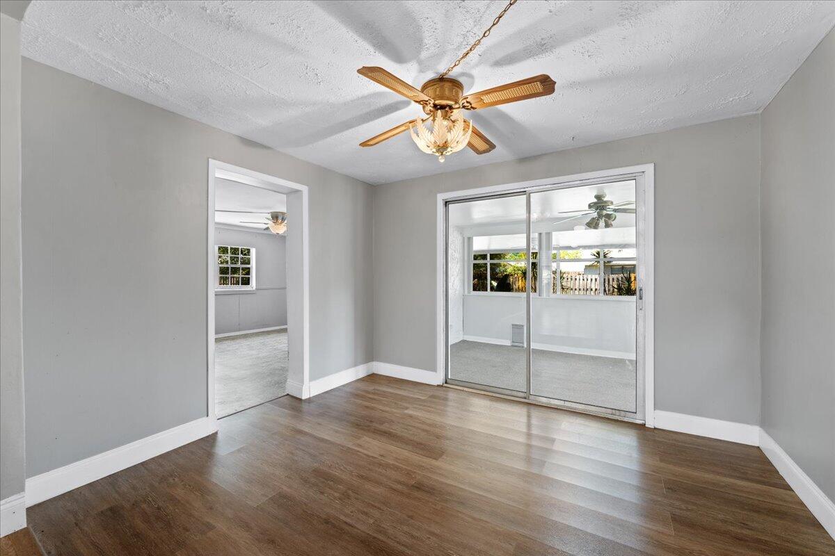 3308 Purdue Street Melbourne, FL 32901 - Photo 11 of 43 wooden floor in an empty room with a window