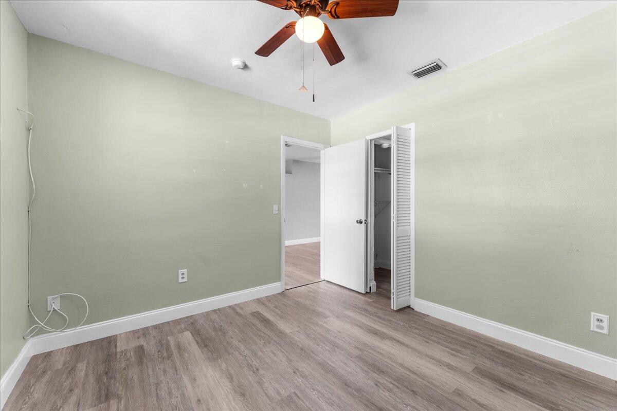 3308 Purdue Street Melbourne, FL 32901 - Photo 15 of 43 a view of room with hardwood floor and ceiling fan