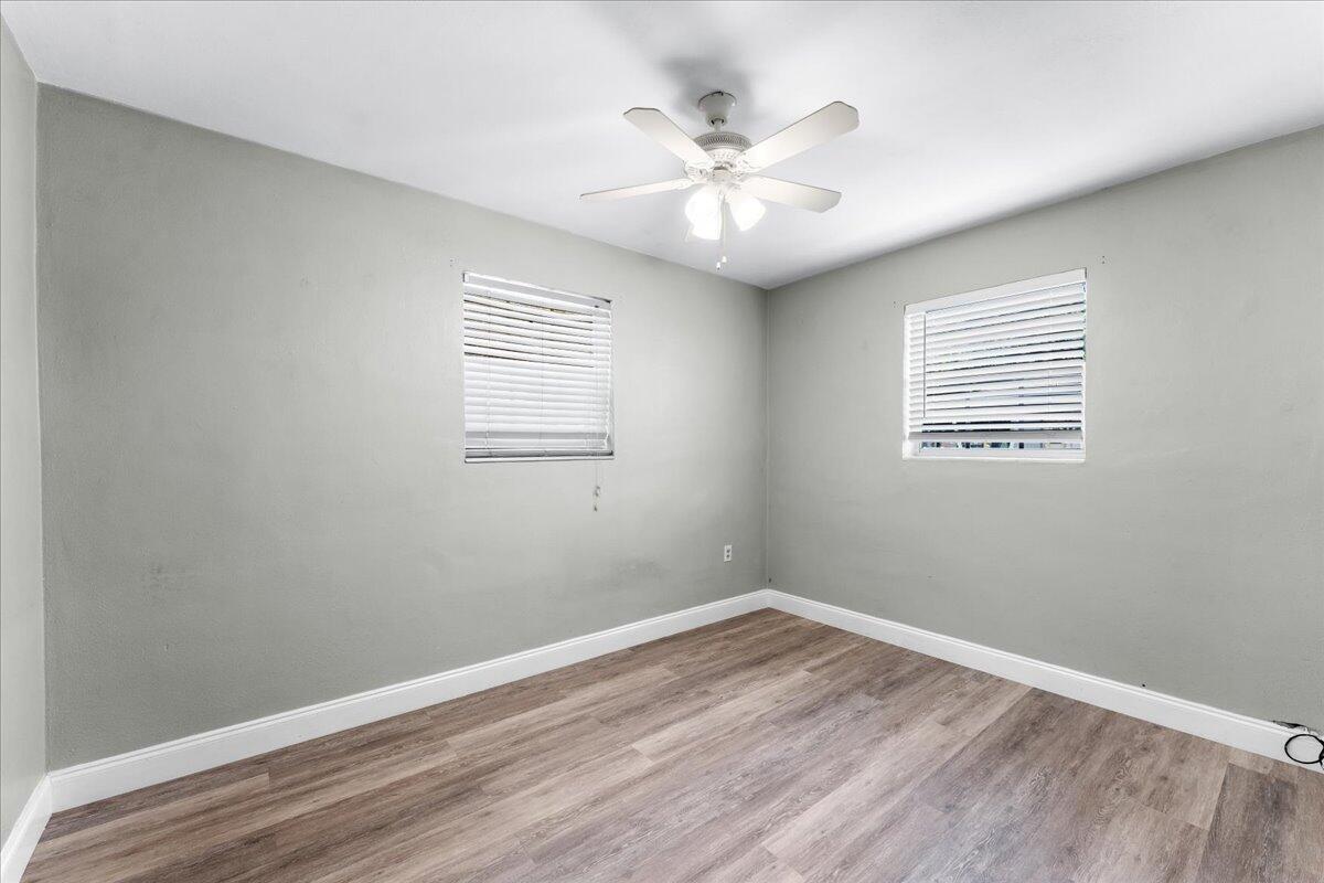 3308 Purdue Street Melbourne, FL 32901 - Photo 19 of 43 an empty room with wooden floor and windows