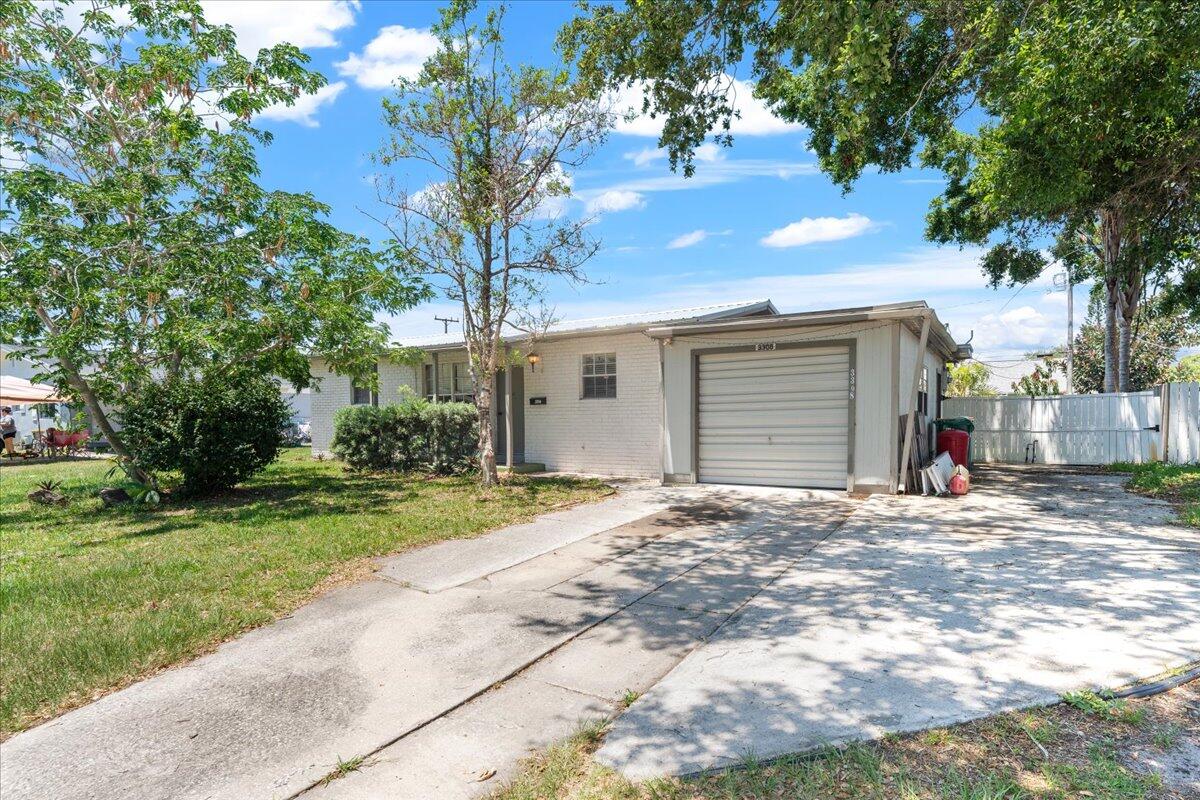 3308 Purdue Street Melbourne, FL 32901 - Photo 2 of 43 a front view of a house with a yard and garage