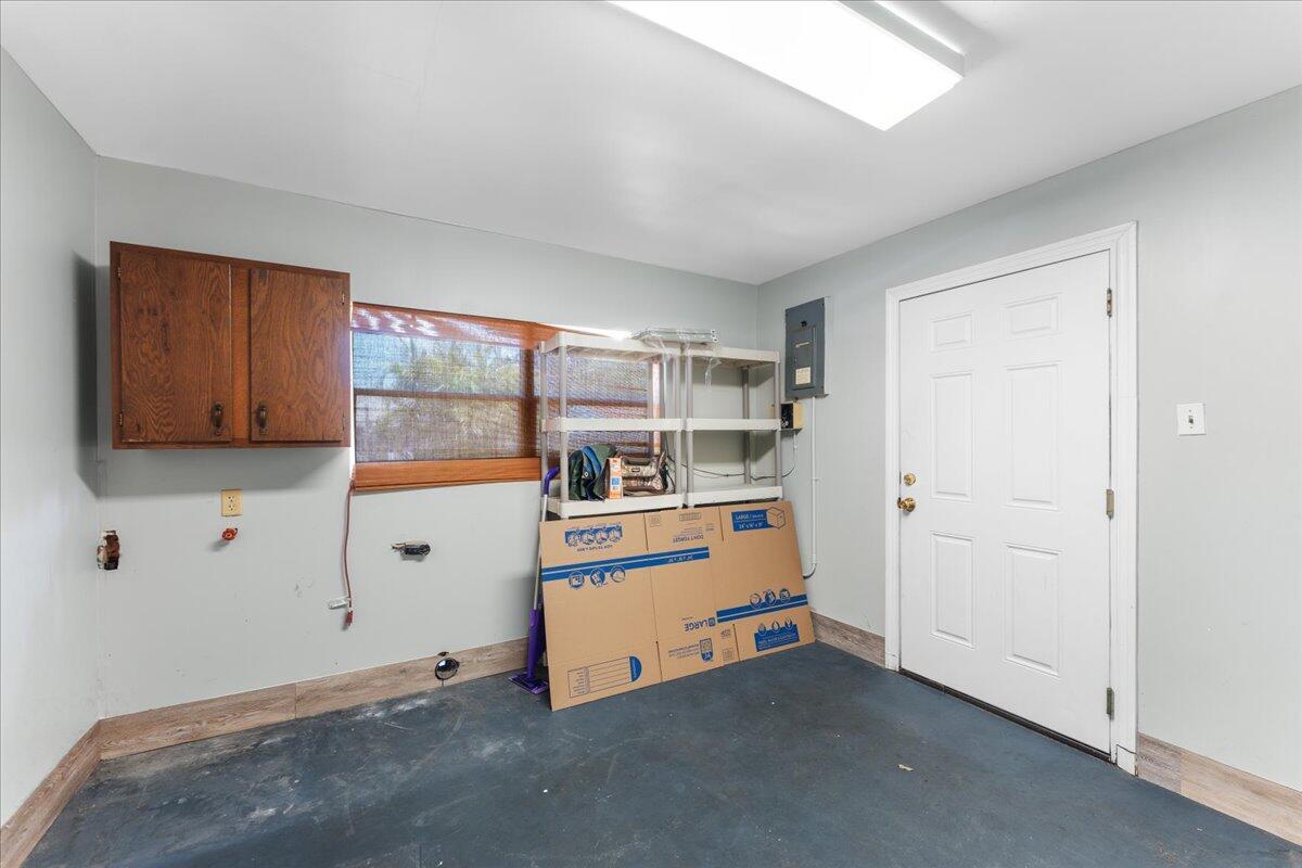 3308 Purdue Street Melbourne, FL 32901 - Photo 23 of 43 a view of a room with cabinet flat screen tv and window