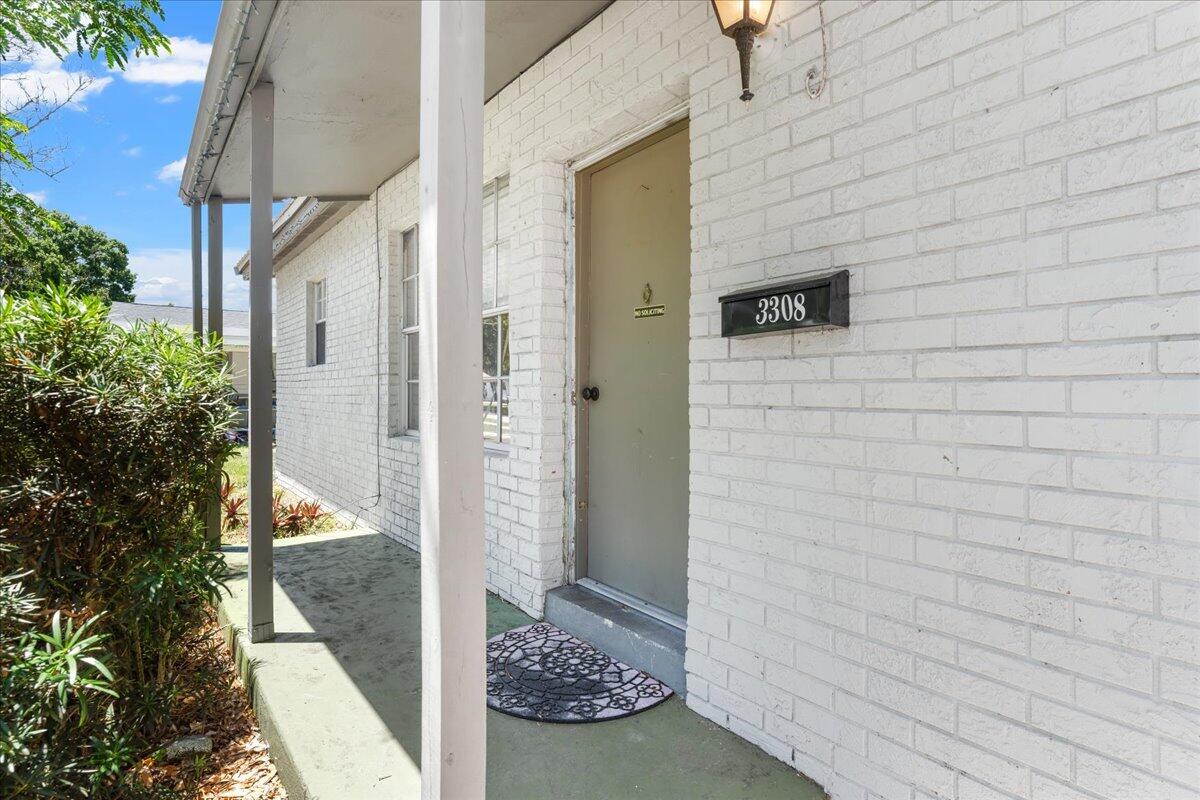 3308 Purdue Street Melbourne, FL 32901 - Photo 3 of 43 a view of a door and chair in front of door
