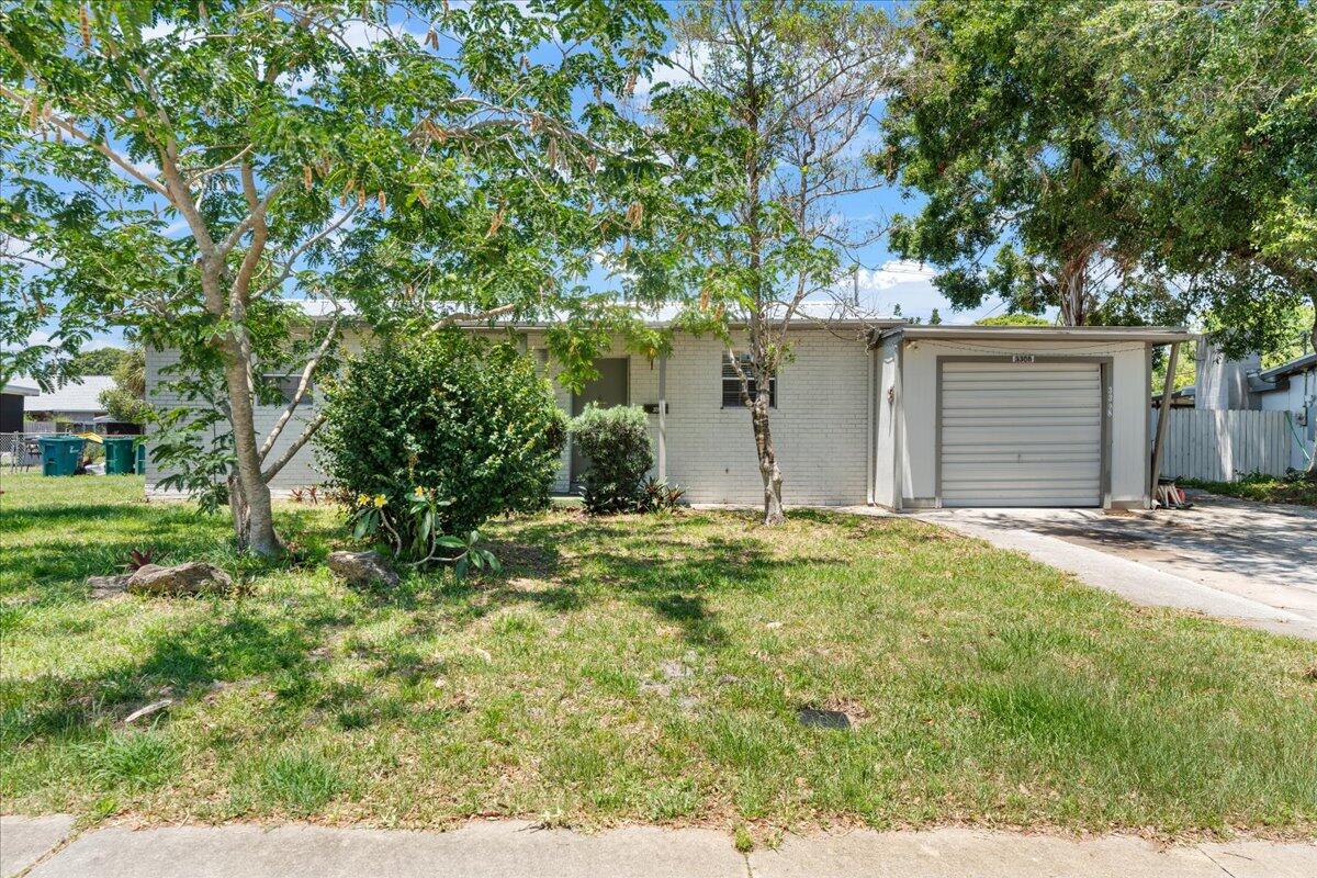 3308 Purdue Street Melbourne, FL 32901 - Photo 41 of 43 a backyard of a house with plants and trees