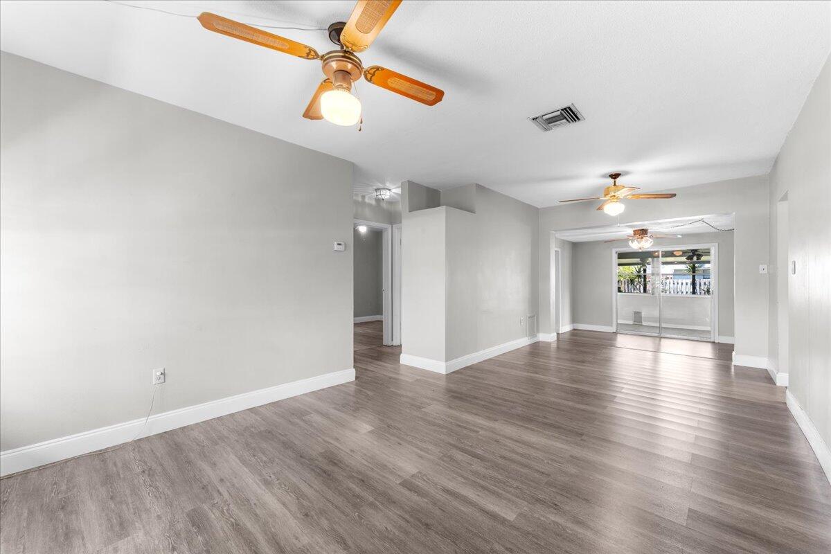 3308 Purdue Street Melbourne, FL 32901 - Photo 5 of 43 wooden floor in an empty room with a window