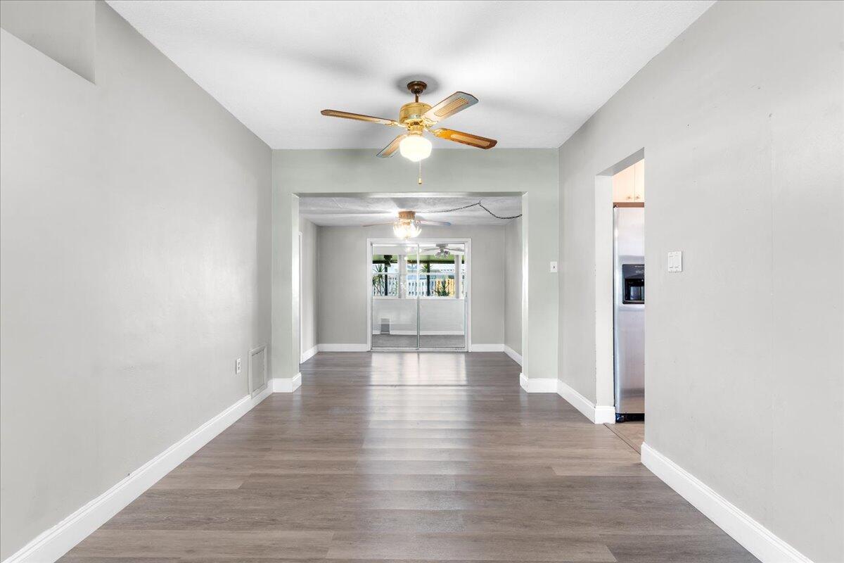 3308 Purdue Street Melbourne, FL 32901 - Photo 6 of 43 a view of an empty room with window and wooden floor