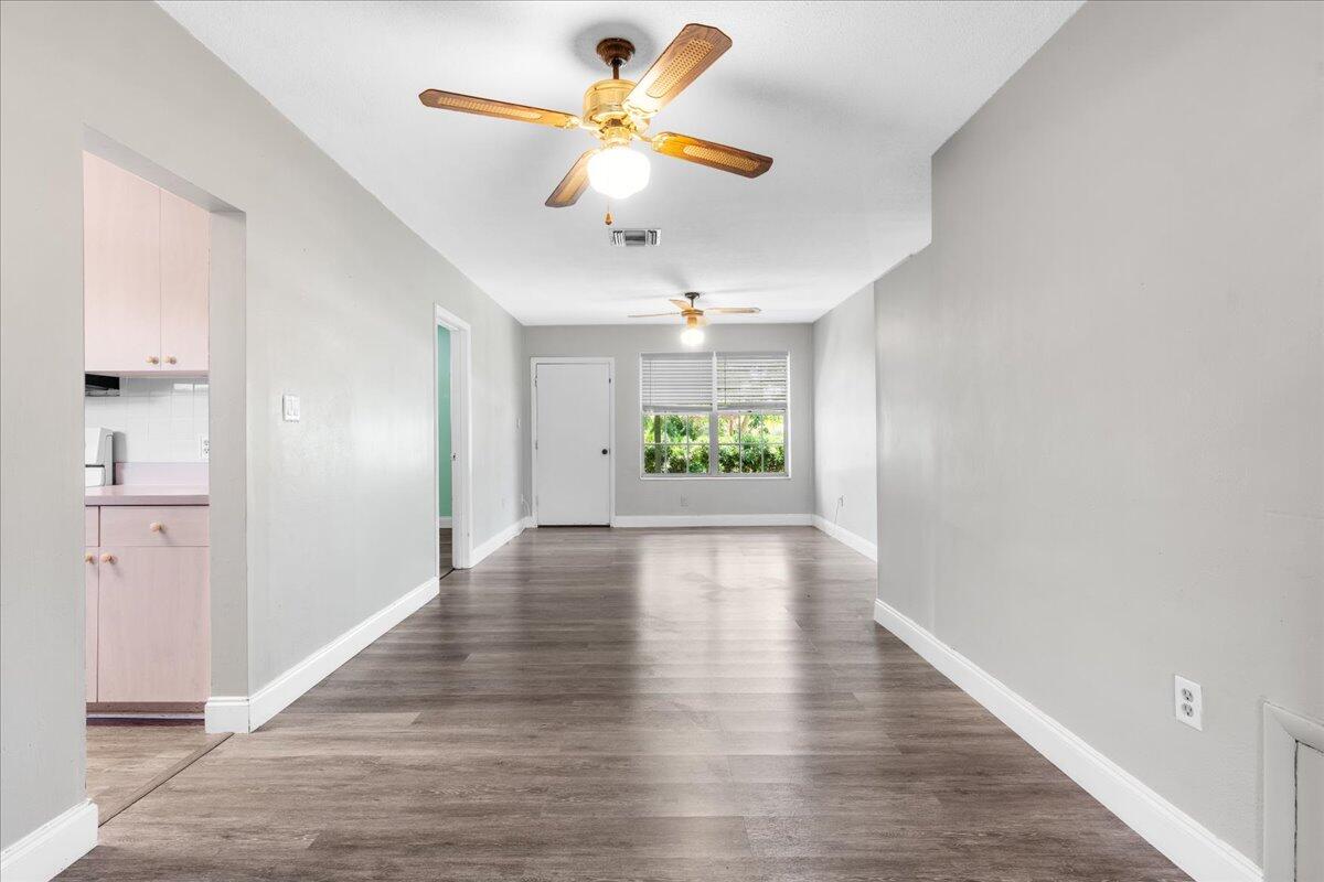 3308 Purdue Street Melbourne, FL 32901 - Photo 7 of 43 a view of an empty room and window with wooden floor