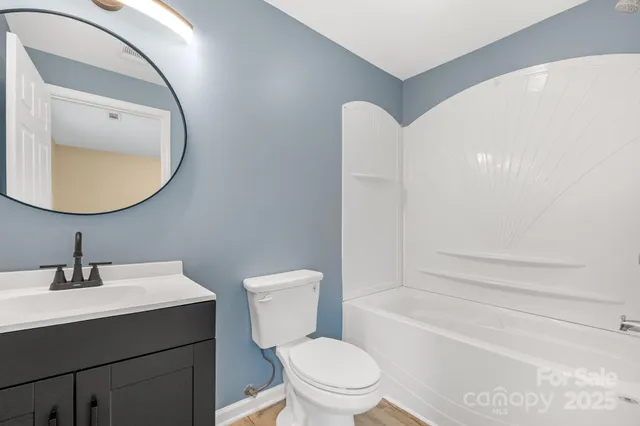 a bathroom with a sink mirror toilet and bathtub