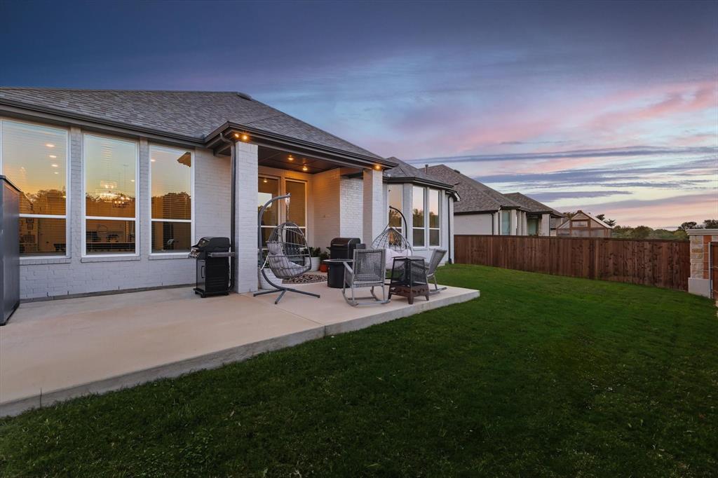 4608 Mount Vista Road Oak Point, TX 75068 - Photo 38 of 39 Expansive backyard featuring a manicured lawn, a full-height privacy fence, and a concrete patio
