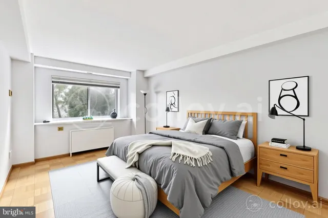 a bedroom with a bed and window with chair