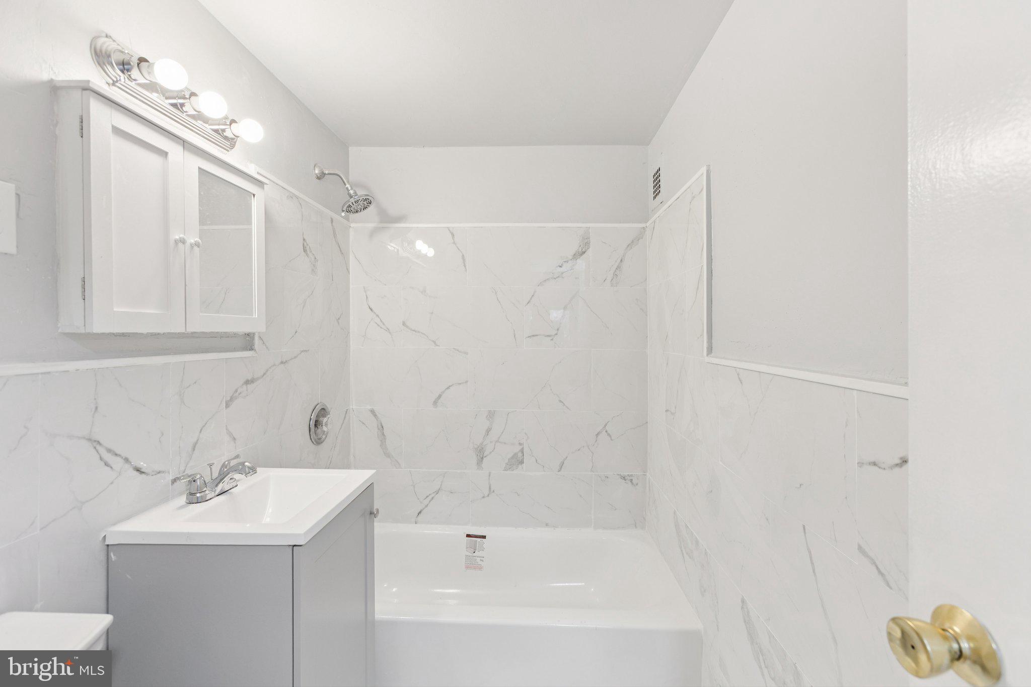 730 24th Street Northwest, Unit 321 Washington, DC 20037 - Photo 17 of 29 a bathroom with a bathtub a sink a toilet and a shower