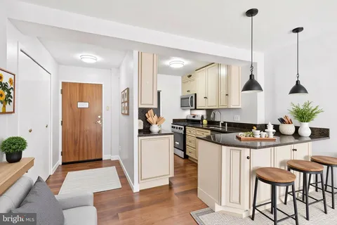 a kitchen with stainless steel appliances kitchen island granite countertop a stove a sink and a refrigerator