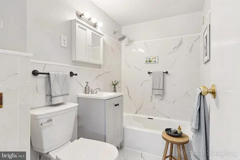a white toilet sitting next to a bathroom sink