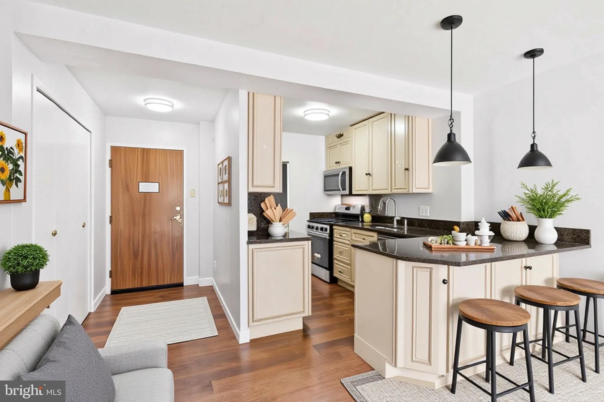 730 24th Street Northwest, Unit 321 Washington, DC 20037 - Photo 5 of 20 a kitchen with stainless steel appliances kitchen island granite countertop a stove a sink and a refrigerator