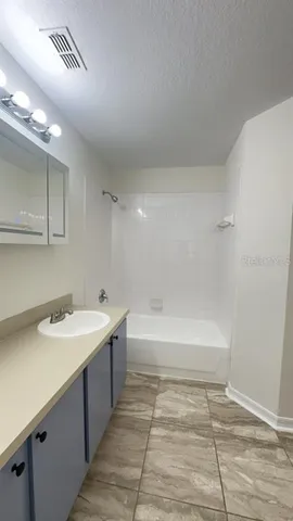 a bathroom with a sink a toilet and bathtub