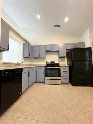 a kitchen with a refrigerator and a sink