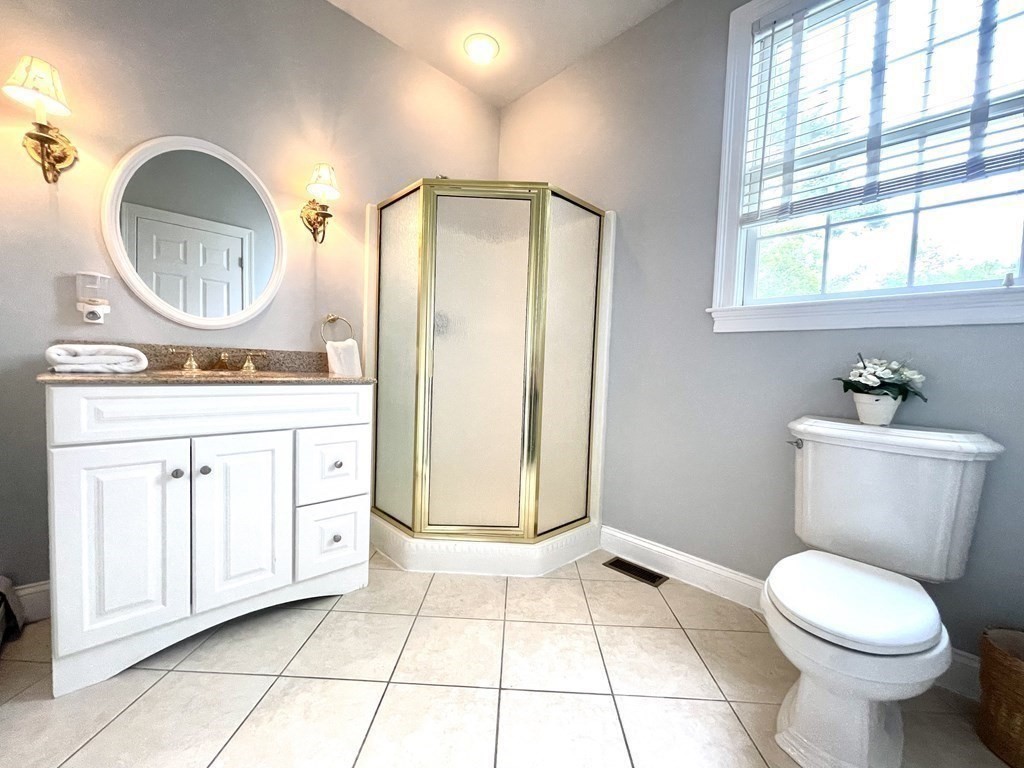 148 Hillcrest Road Marshfield, MA 02050 - Photo 17 of 42 a bathroom with a sink a toilet and a mirror