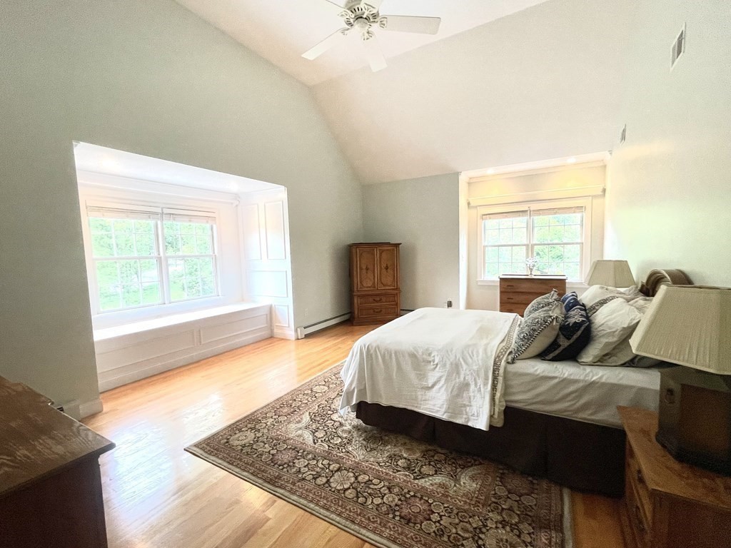 148 Hillcrest Road Marshfield, MA 02050 - Photo 19 of 42 a bedroom with a bed and wooden floor
