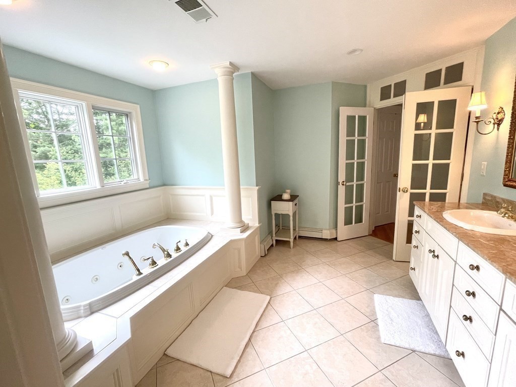 148 Hillcrest Road Marshfield, MA 02050 - Photo 21 of 42 a spacious bathroom with a tub sink and a mirror
