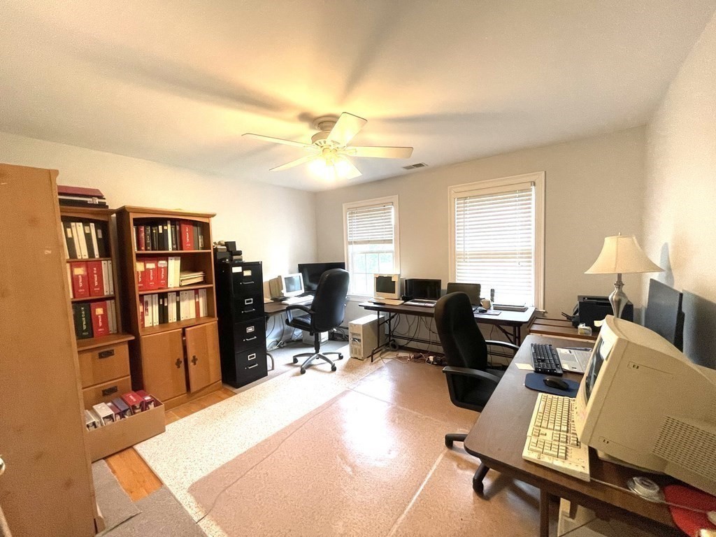 148 Hillcrest Road Marshfield, MA 02050 - Photo 27 of 42 a living room with furniture a bookshelf and a window