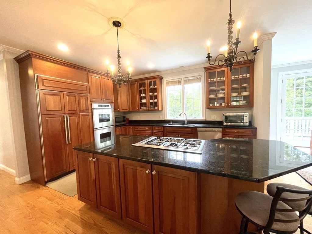 148 Hillcrest Road Marshfield, MA 02050 - Photo 8 of 42 a kitchen with stainless steel appliances granite countertop a stove a sink dishwasher and cabinets with wooden floor