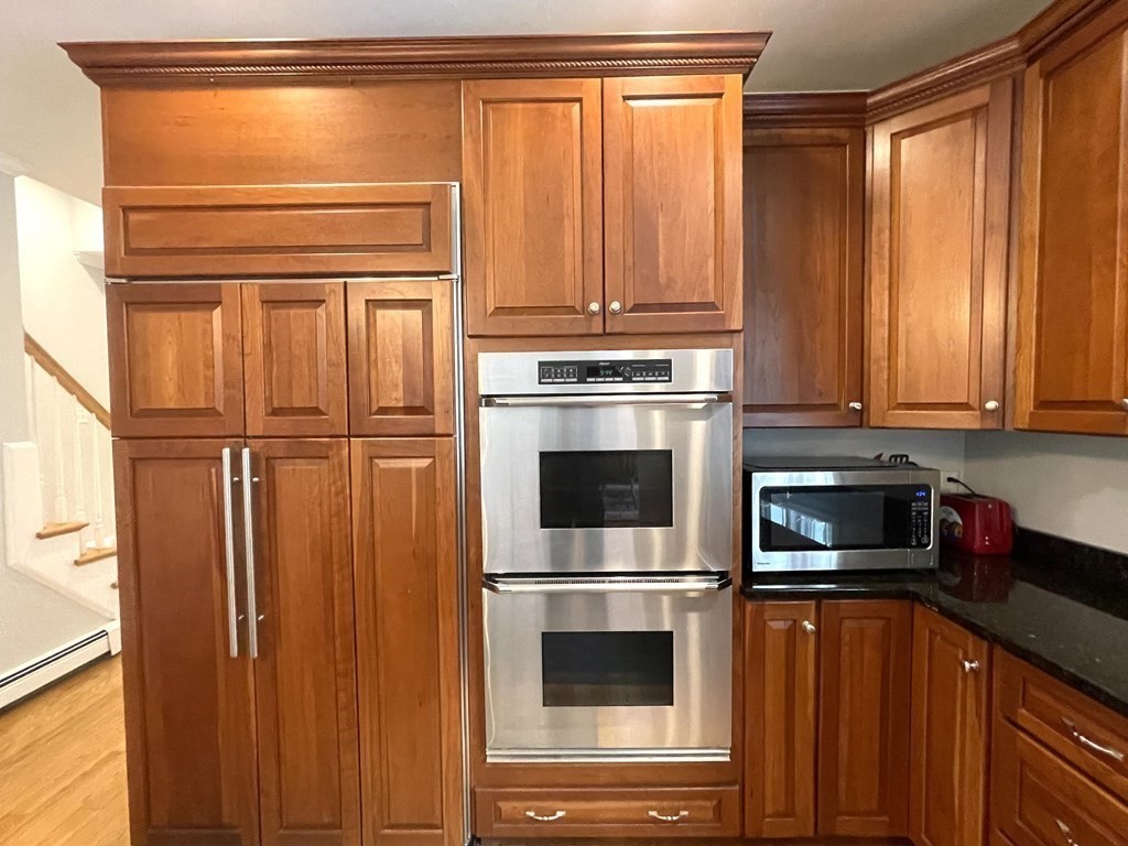 148 Hillcrest Road Marshfield, MA 02050 - Photo 9 of 42 a kitchen with stainless steel appliances granite countertop a refrigerator and cabinets