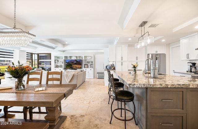 a kitchen with lots of counter top space and dining room