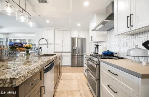 a kitchen with refrigerator and cabinets