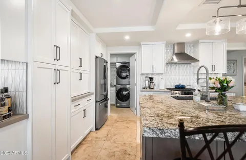a bedroom with a bed and large windows