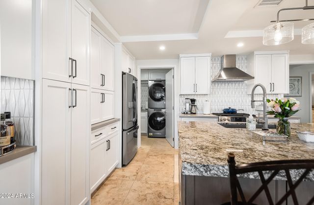 a bedroom with a bed and large windows