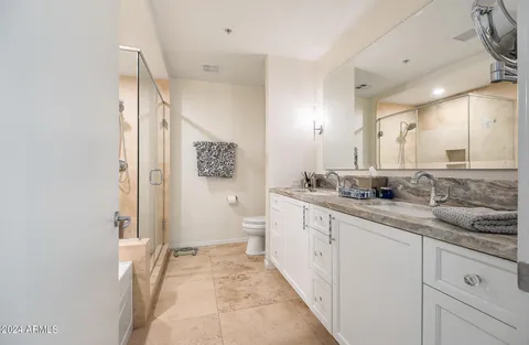 a bathroom with a toilet sink and a shower