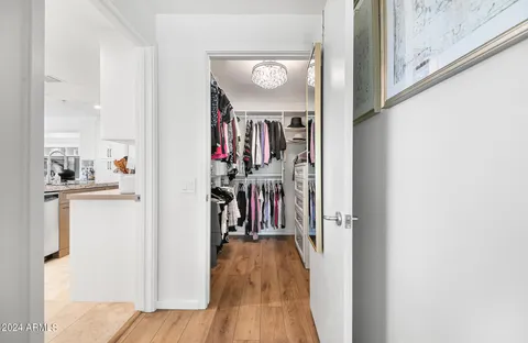 a bedroom with a large bed and a flat tv screen on dresser