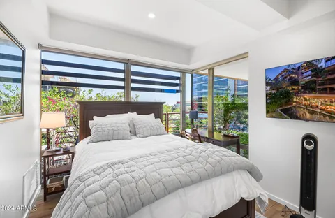 a view of kitchen with stainless steel appliances kitchen island wooden cabinets and fireplace