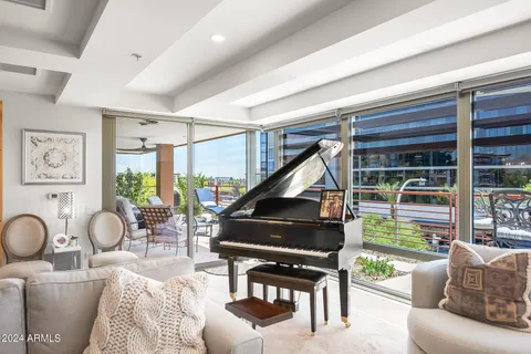 a living room with furniture and a floor to ceiling window