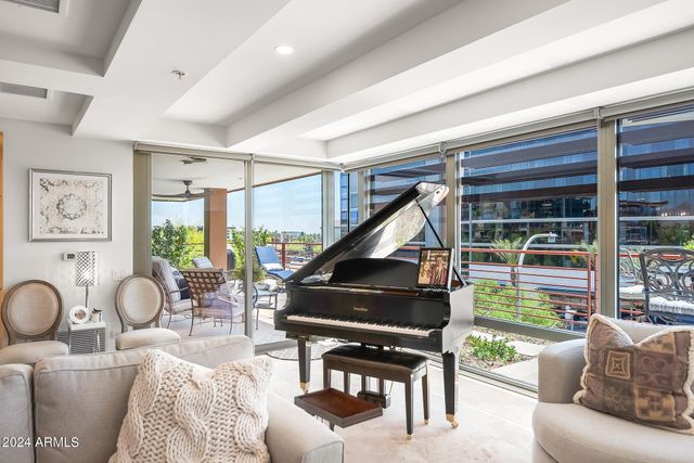 a living room with furniture and a floor to ceiling window