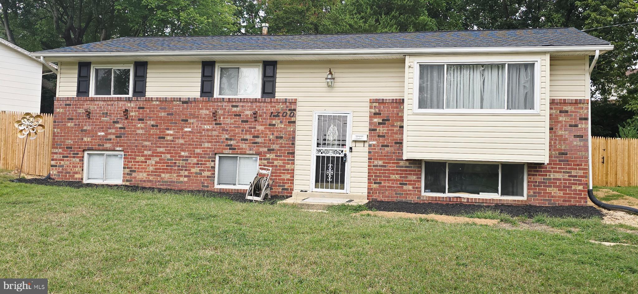1700 Jarvis Avenue Oxon Hill, MD 20745 - Photo 1 of 15 a front view of a house with a yard