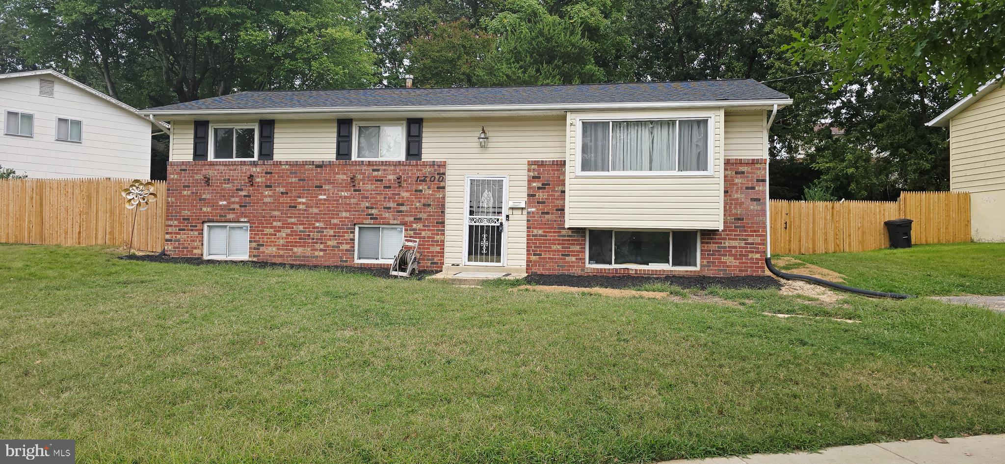 1700 Jarvis Avenue Oxon Hill, MD 20745 - Photo 14 of 15 a front view of a house with a garden
