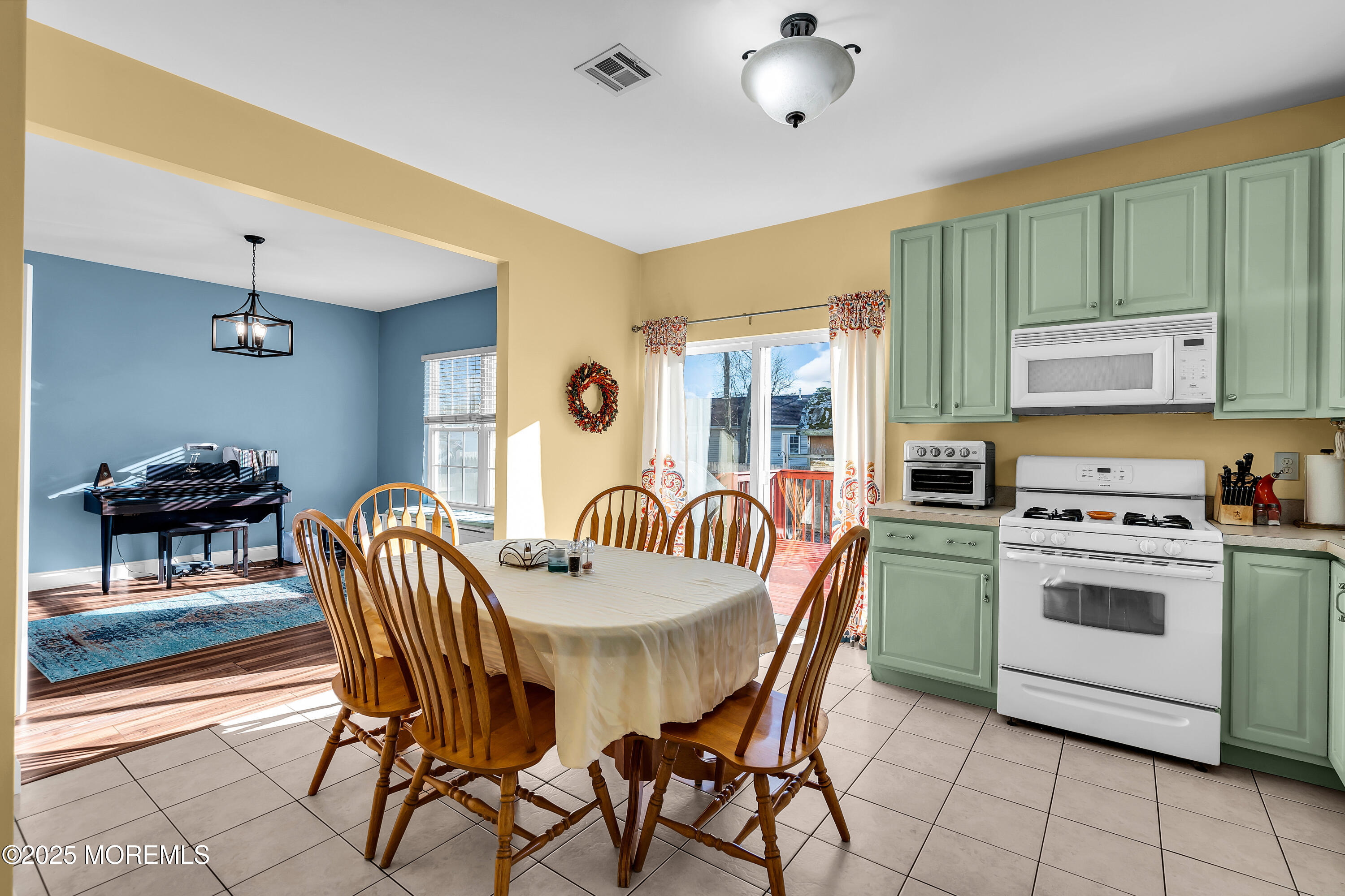 1007 Inland Road Forked River, NJ 08731 - Photo 8 of 27 a view of a dining room with furniture and chandelier