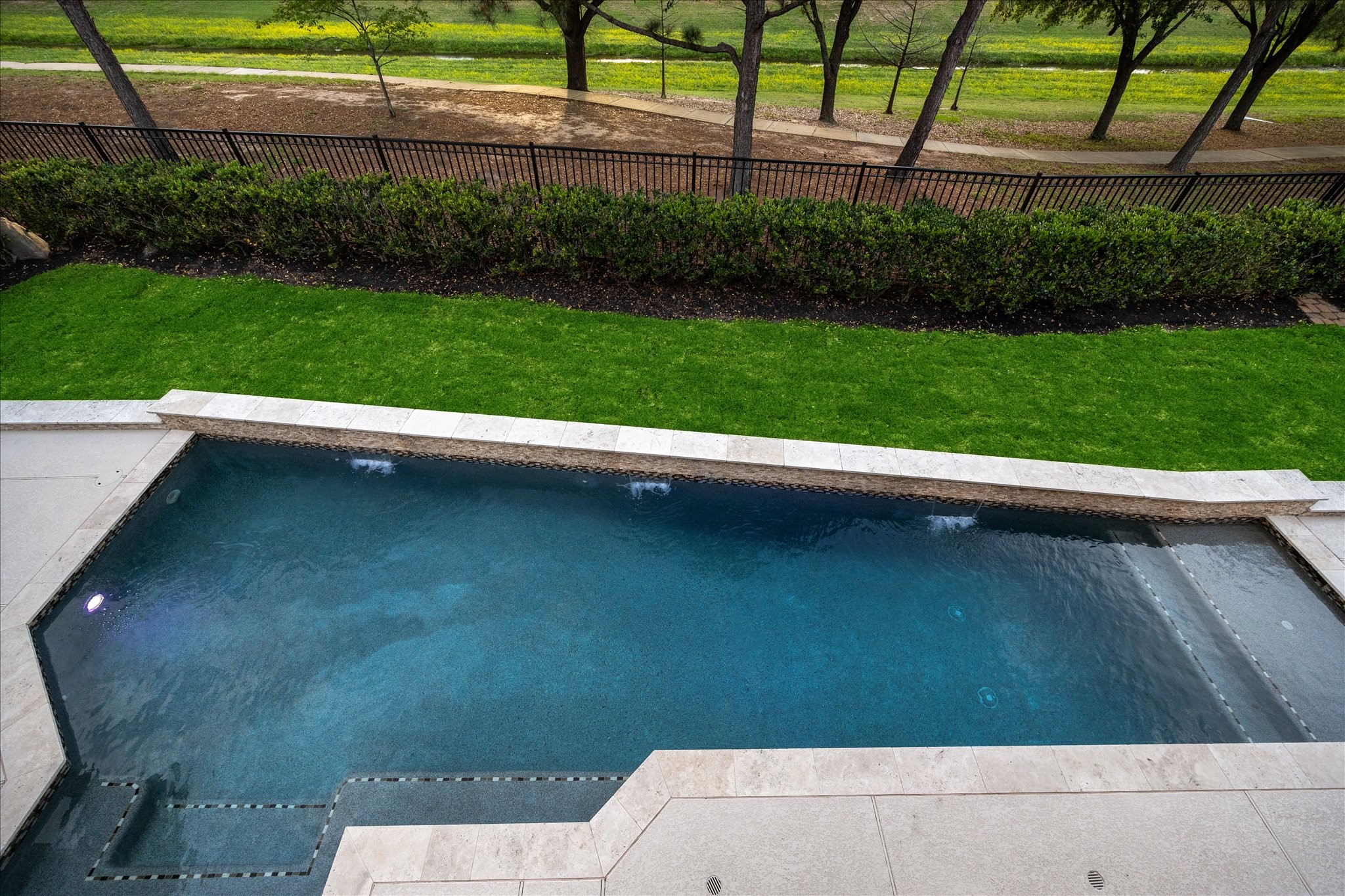 6211 Alameda Point Lane Houston, TX 77041 - Photo 32 of 50 Stunning saltwater pool and spa showcasing the expansive patio, lush greenspace, and park-like lot with no back neighbors.