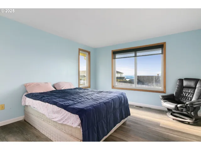 a bedroom with a bed a table and chair