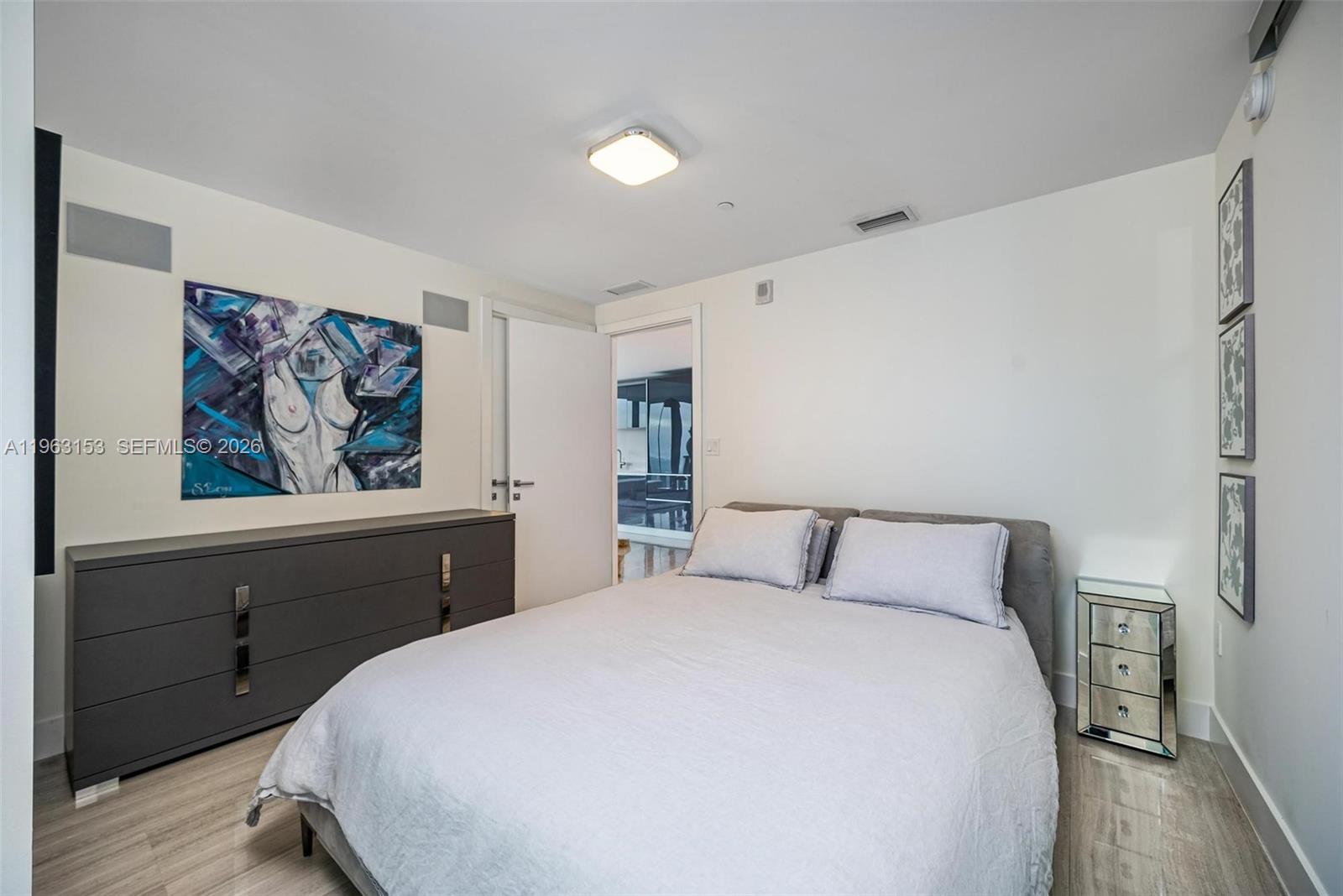 1451 Brickell Avenue, Unit 2204 Miami, FL 33131 - Photo 11 of 29 a bedroom with a bed and a painting on the wall