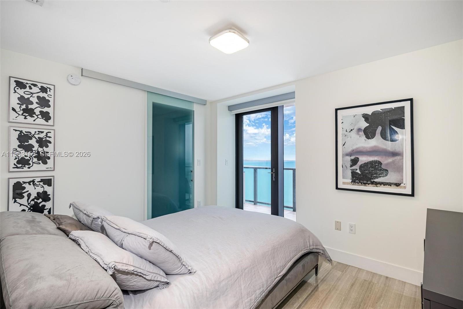 1451 Brickell Avenue, Unit 2204 Miami, FL 33131 - Photo 12 of 29 a bedroom with a bed and a painting on the wall