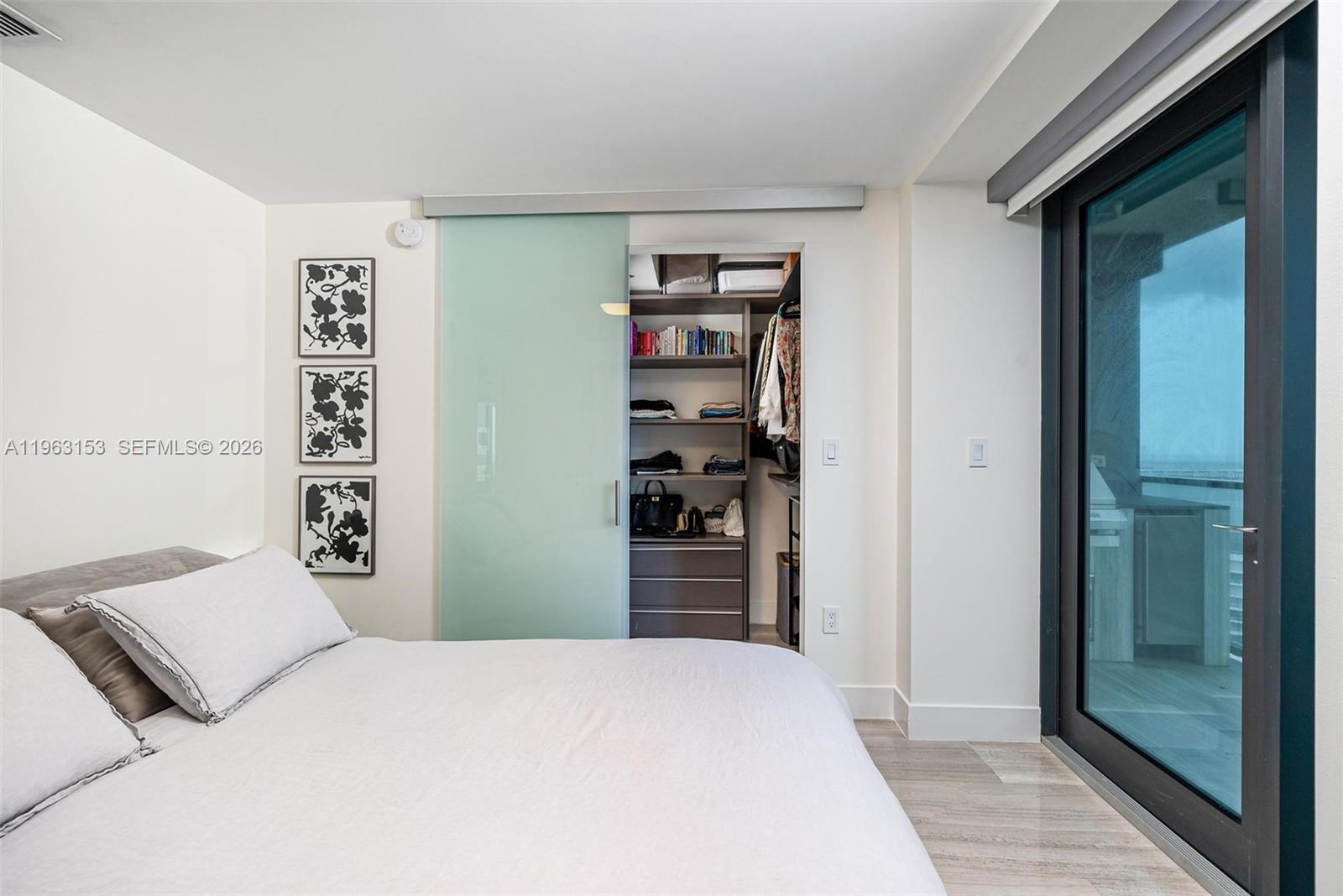 1451 Brickell Avenue, Unit 2204 Miami, FL 33131 - Photo 13 of 29 a bedroom with a bed and a cabinets