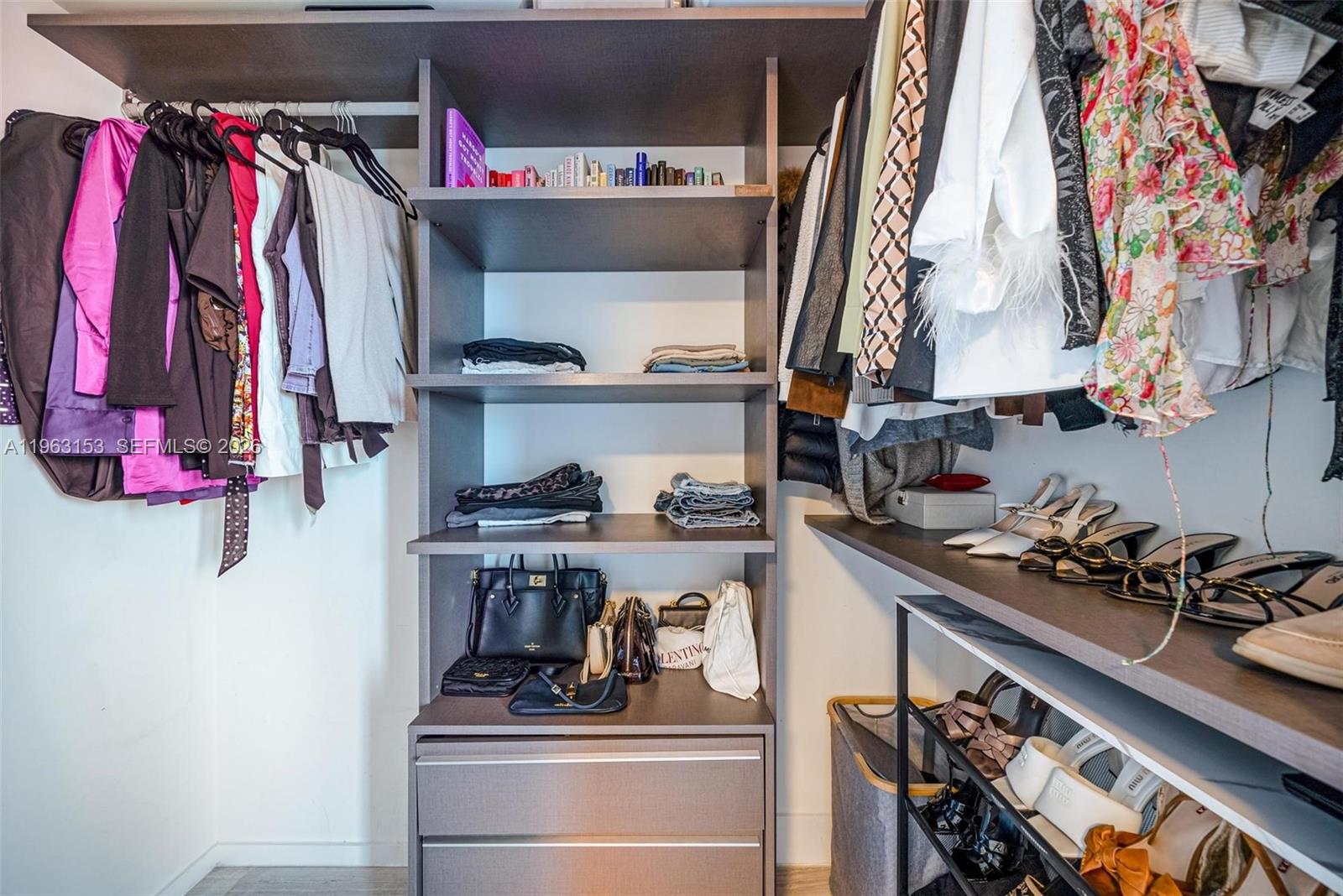 1451 Brickell Avenue, Unit 2204 Miami, FL 33131 - Photo 14 of 29 a room with lots of different colored cloths