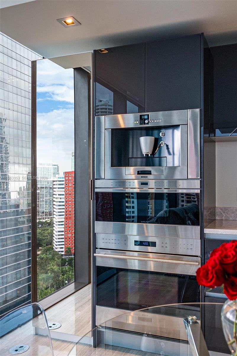 1451 Brickell Avenue, Unit 2204 Miami, FL 33131 - Photo 19 of 29 a kitchen with a stove and a microwave