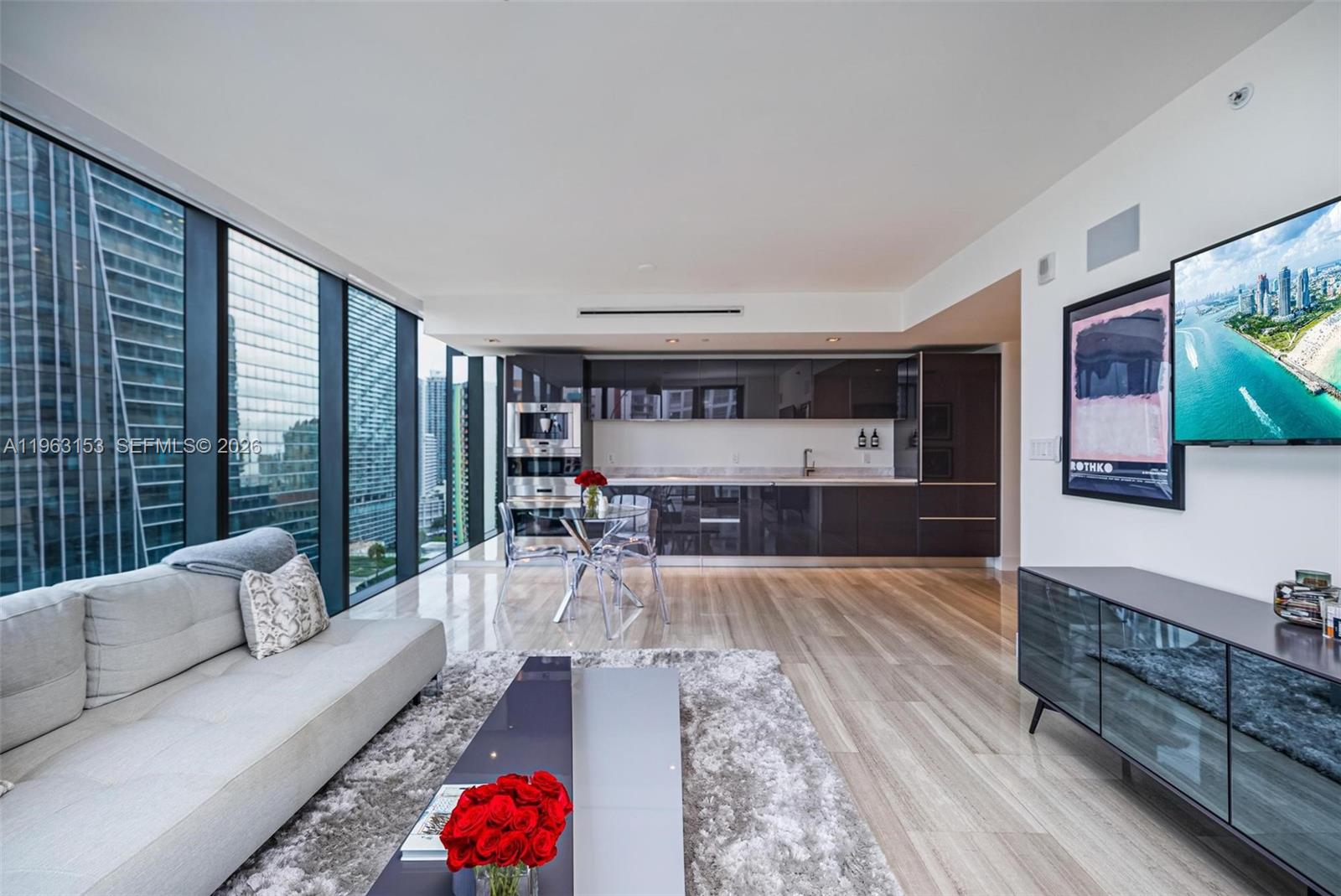 1451 Brickell Avenue, Unit 2204 Miami, FL 33131 - Photo 6 of 29 a living room with furniture and a flat screen tv