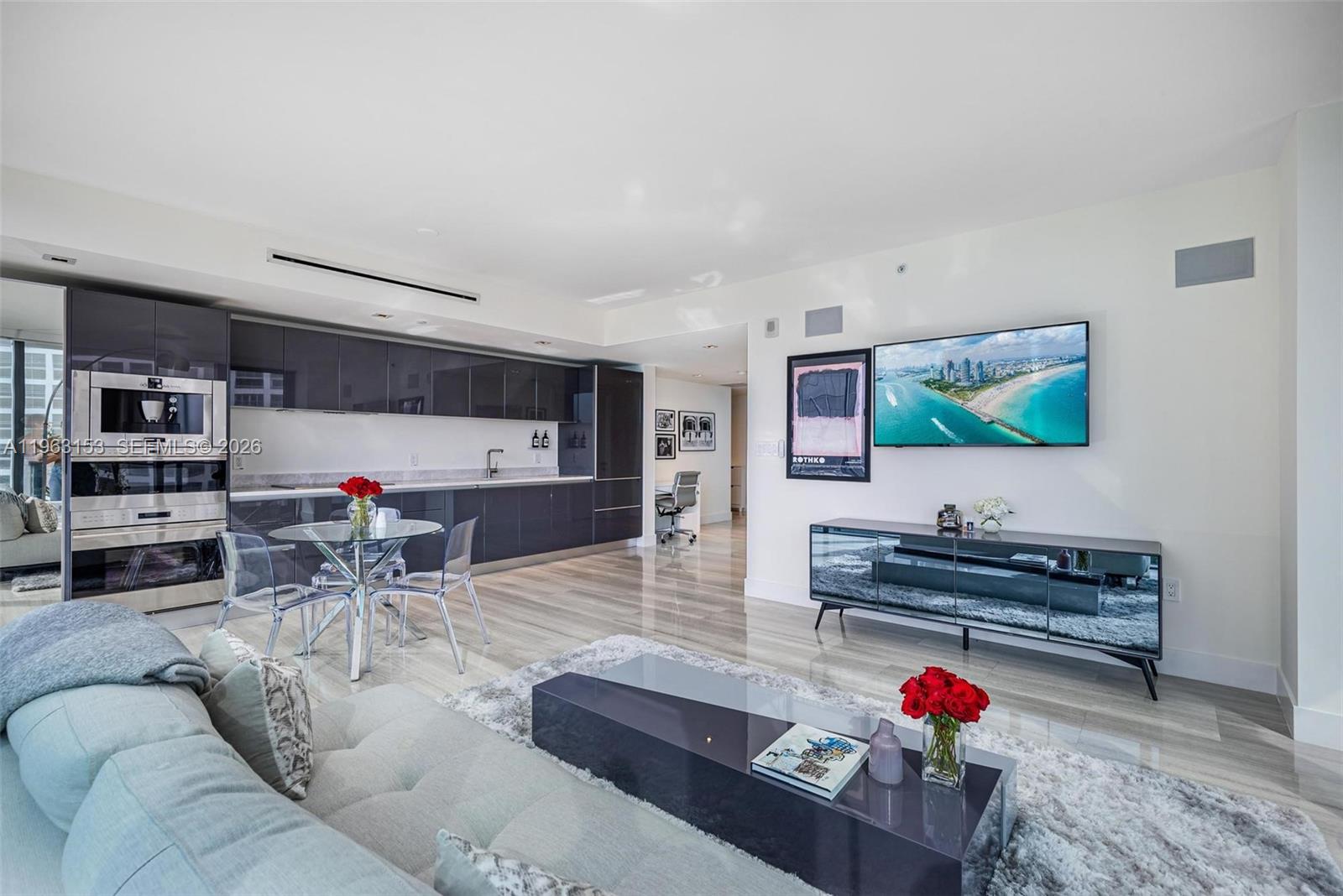 1451 Brickell Avenue, Unit 2204 Miami, FL 33131 - Photo 10 of 29 a living room with furniture and a flat screen tv